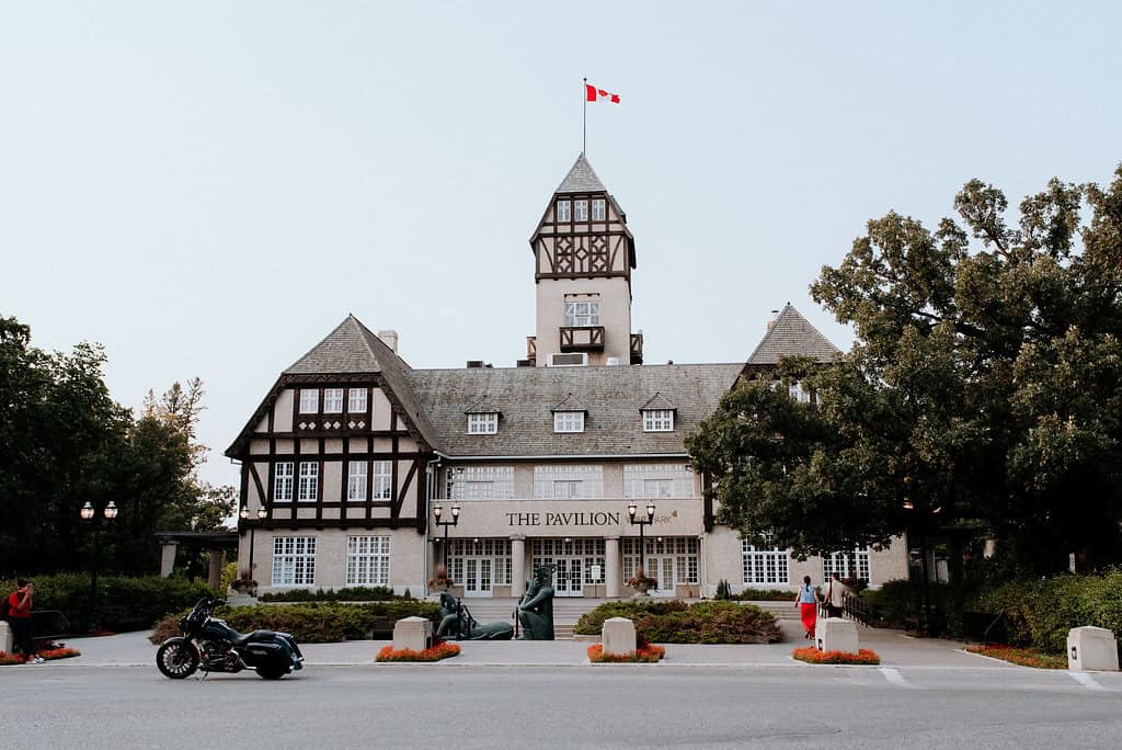 Elegant historic castle-style wedding venue with lush greenery and outdoor decor in Winnipeg. Perfect for romantic wedding ceremonies and upscale events.