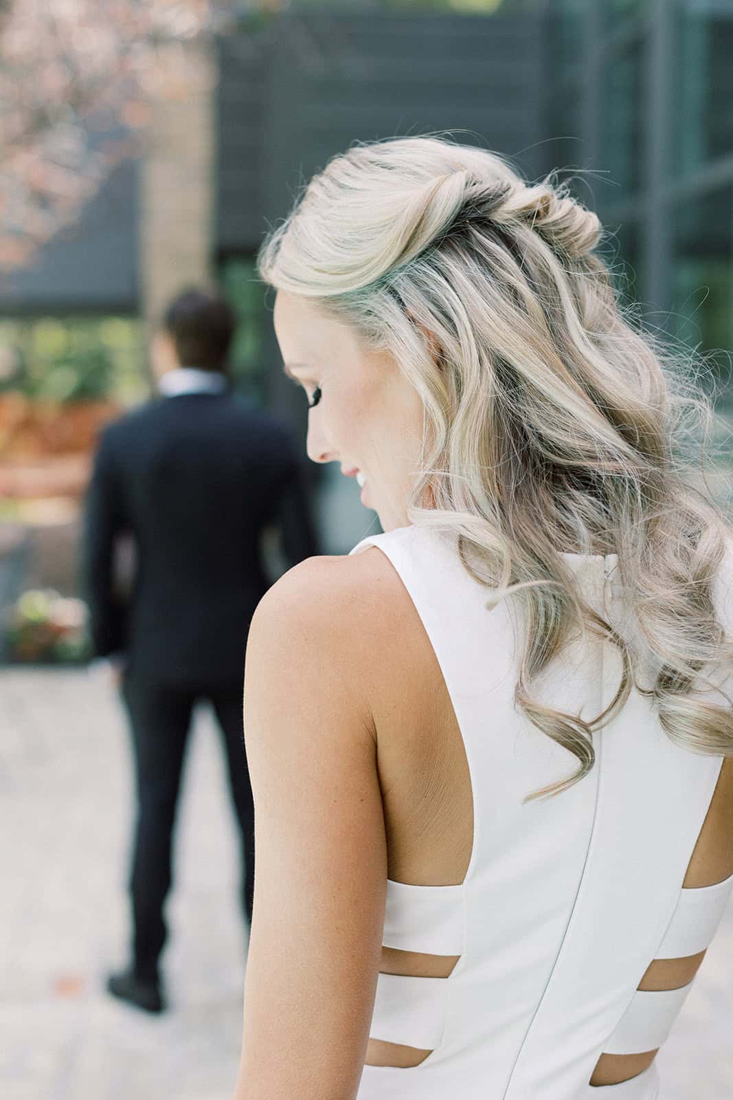Elegant bride with styled blonde hair and white dress at outdoor wedding venue in Winnipeg, captured by Melanie Parent Events.