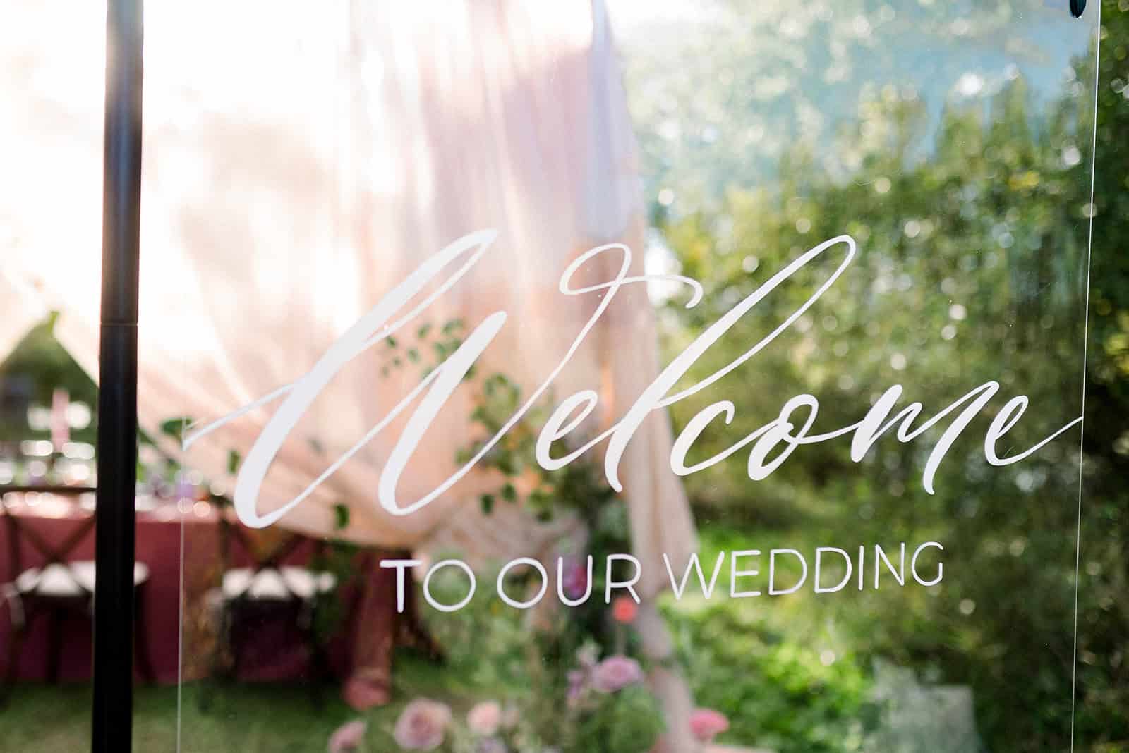Elegant wedding welcome sign with "Welcome to our wedding" in stylish script font, serving as a beautiful backdrop for outdoor wedding decor in Winnipeg.
