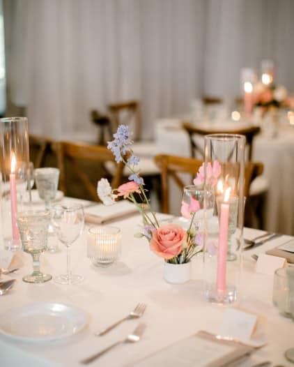 Elegant wedding reception table setup with floral centerpieces and candles at Melanie Parent Events in Winnipeg.