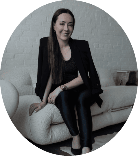 Elegant woman in professional attire sitting on a cream-colored sofa in a modern, stylish setting for Melanie Parent Events in Winnipeg.